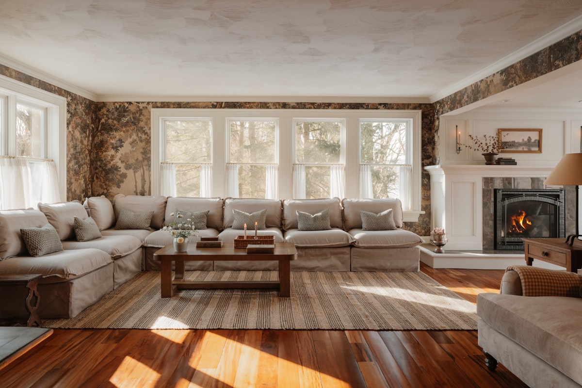 Row of casement windows in a warm living room with a fireplace